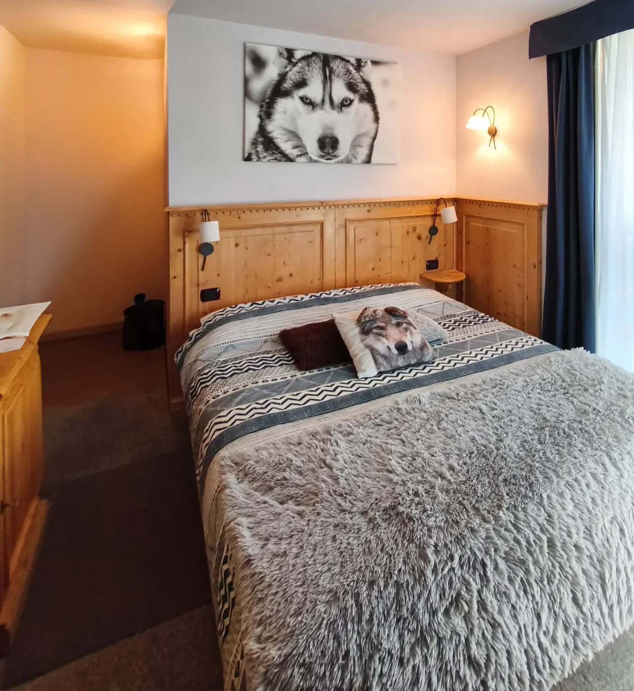 Interno camera Shackleton Chalet con letto matrimoniale, stile alpino moderno in legno naturale.